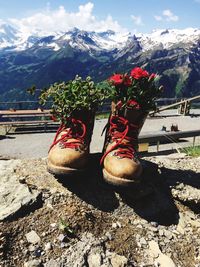 High angle view of shoes on mountain against sky