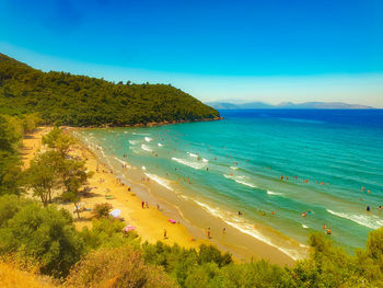 Scenic view of bay against clear blue sky