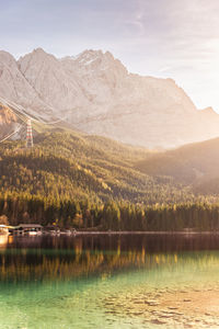 Scenic view of lake and mountains against sky during sunset