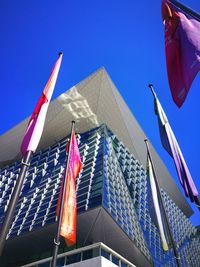 Low angle view of modern building against blue sky