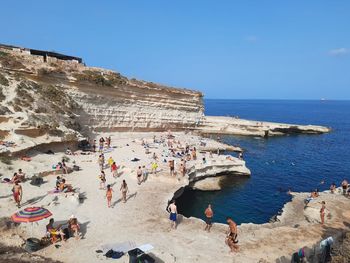 People on beach against sky