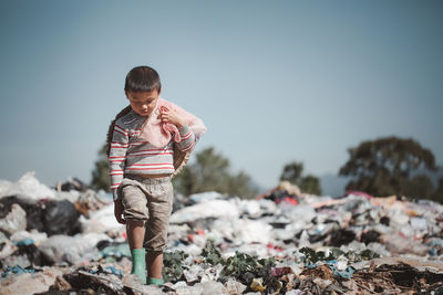 Boy standing against clear sky