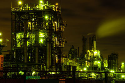 Low angle view of illuminated buildings against sky at night