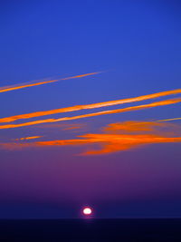 Scenic view of sea against orange sky