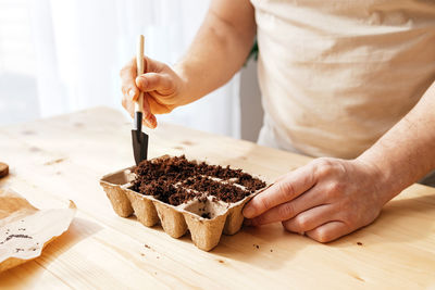 Cropped hand of person preparing food