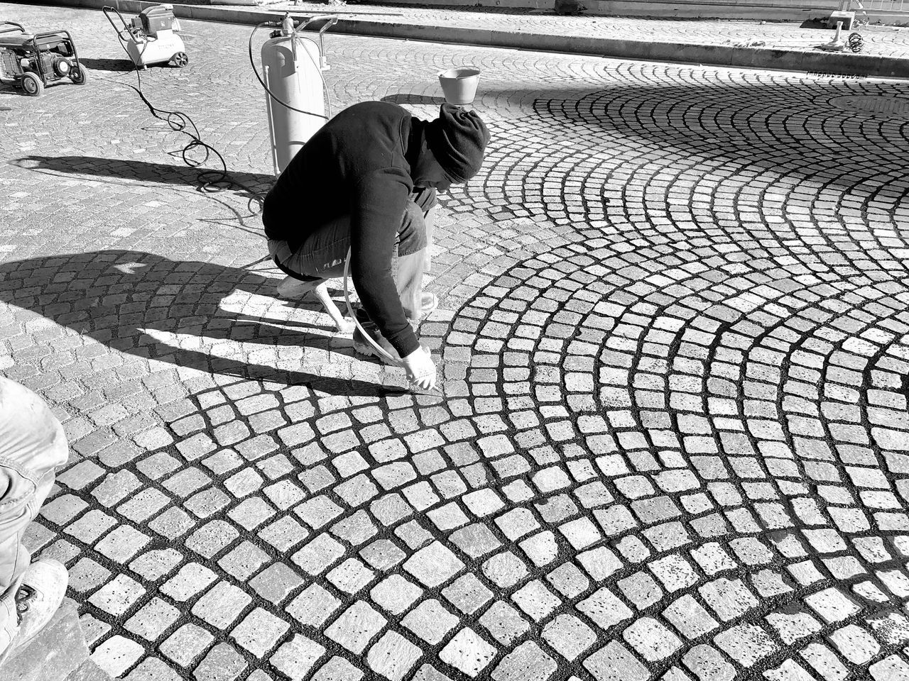 HIGH ANGLE VIEW OF WOMAN WALKING ON FOOTPATH