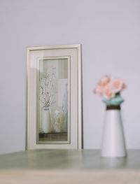 Flower vase against wall at home