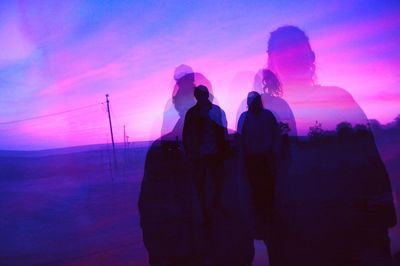 Silhouette of people at sunset