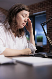 Young woman using laptop on table