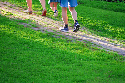 Low section of people walking on footpath