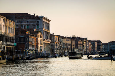 Boats in canal with buildings in background