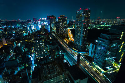 High angle view of illuminated city buildings at night