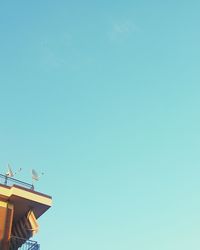 Low angle view of built structure against clear blue sky