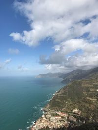Aerial view of townscape by sea against sky