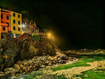 High angle view of illuminated buildings in city at night