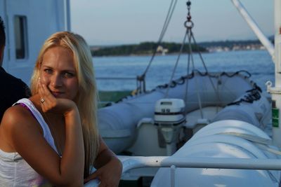 Portrait of woman sitting on boat in sea