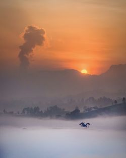 Scenic view of landscape against sky during sunset