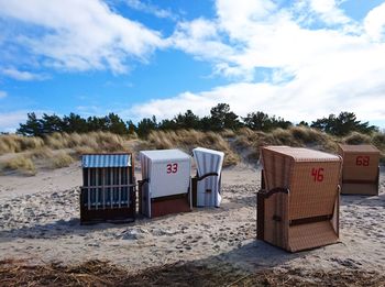Lifeguard hut on beach against sky