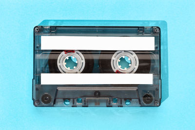 Directly above shot of audio equipment against blue background
