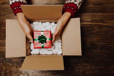 Midsection of man holding paper in box