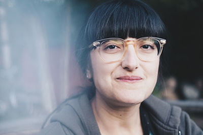 Close-up portrait of smiling woman wearing eyeglasses