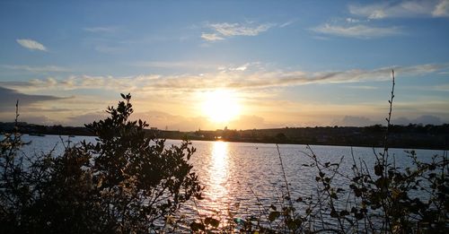 Scenic view of lake against sky during sunset