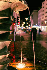 Close-up of fountain in city at night