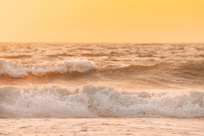 Scenic view of sea against clear sky during sunset