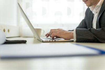 Man using laptop on table