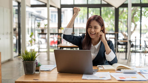 Young woman using laptop on table