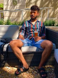 Young man sitting on sofa