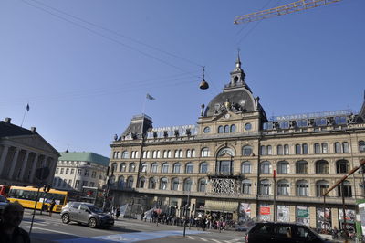 Cars on street against buildings in city