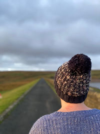 Rear view of woman wearing a knit hat