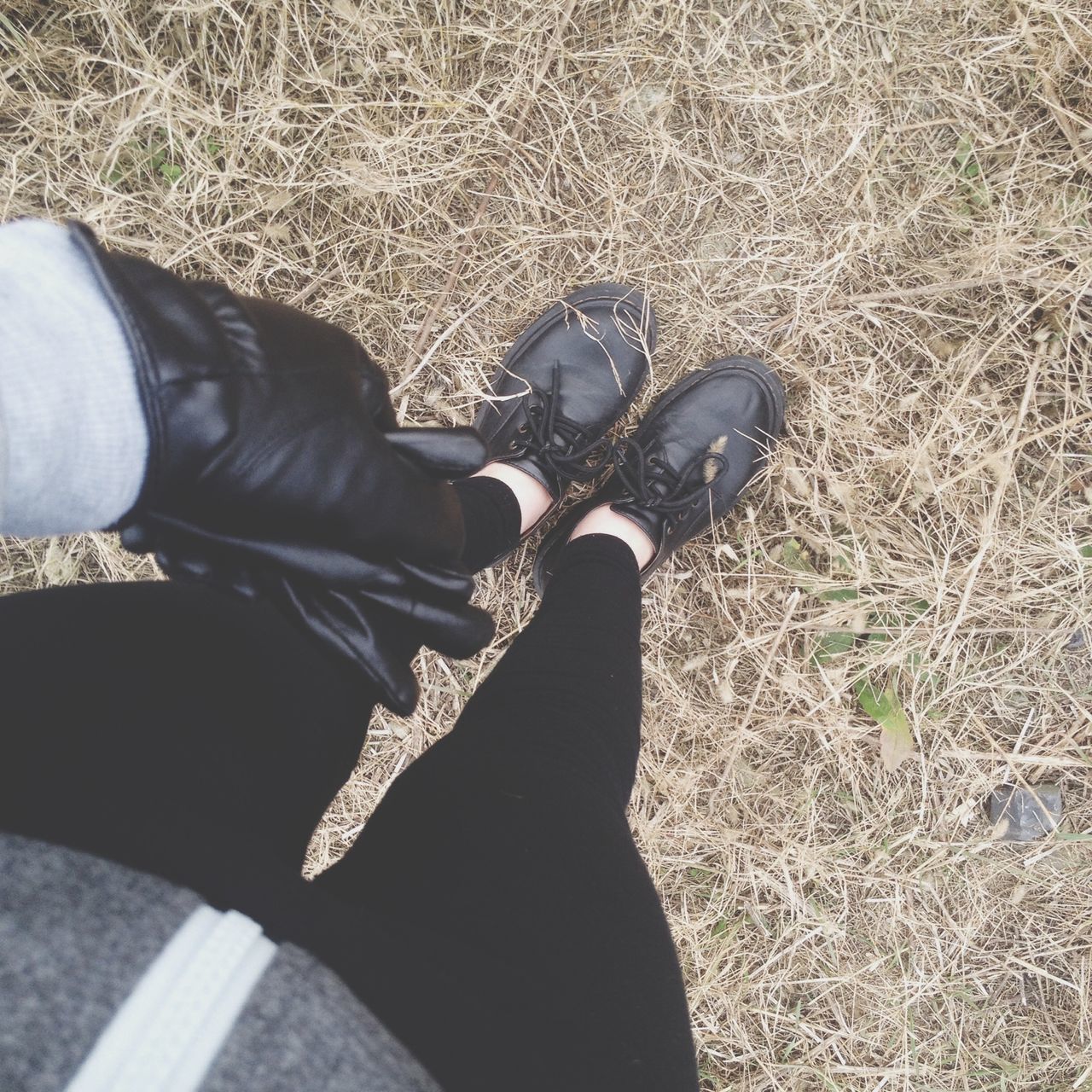 low section, person, shoe, personal perspective, footwear, high angle view, lifestyles, human foot, leisure activity, standing, unrecognizable person, part of, jeans, men, canvas shoe, directly above, field