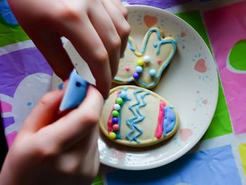 Midsection of woman holding multi colored candies