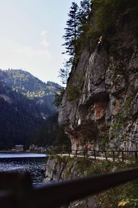 Scenic view of river by mountains against sky