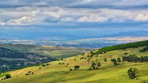 Scenic view of village against cloudy sky