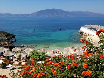 Scenic view of sea and mountains against sky