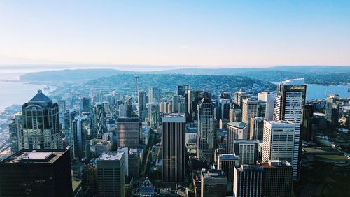 Aerial view of buildings in city against sky