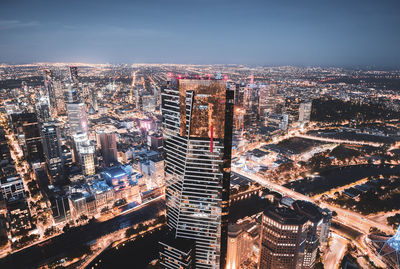 High angle view of city lit up at night