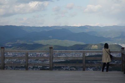 Rear view of woman looking at mountains