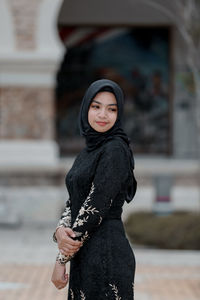 Woman wearing sunglasses standing outdoors