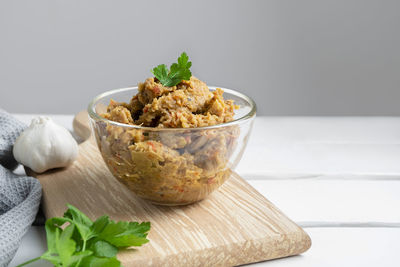 Traditional balkan dish kiopoolu, eggplant  spread in a glass bowl on white table