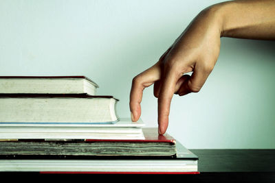 Close-up of human hand on book