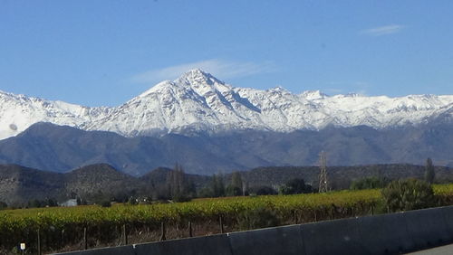 Scenic view of landscape and mountains against blue sky