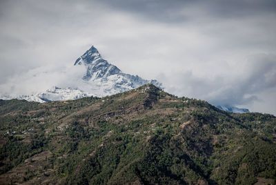 Scenic view of mountains against cloudy sky