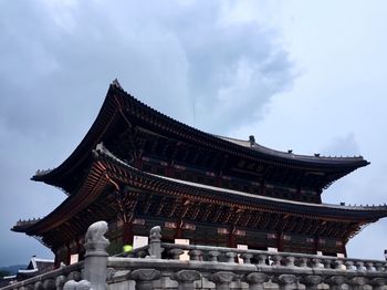 Low angle view of temple against cloudy sky