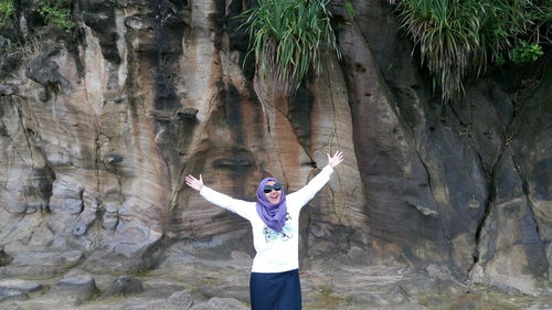 Full length of woman standing on rock