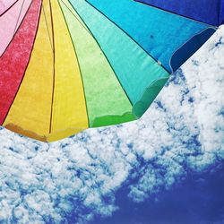 Low angle view of multi colored umbrella against sky