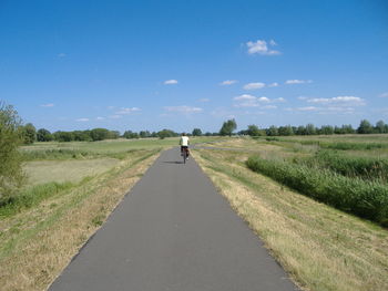 Road passing through grassy field